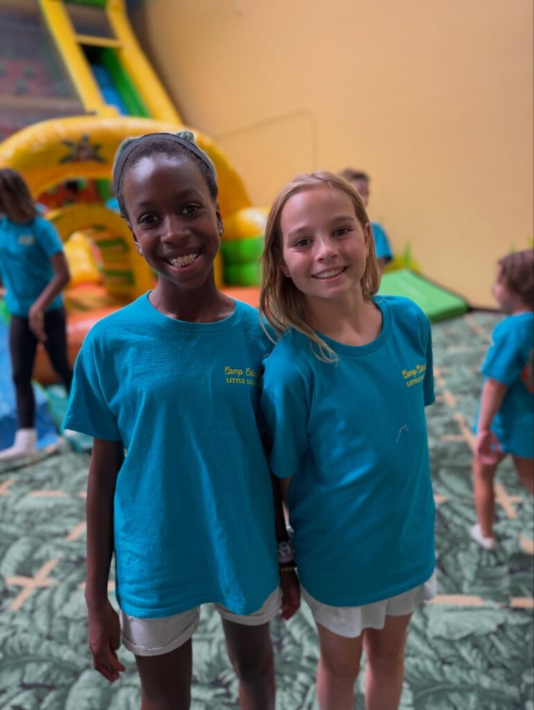Two campers smiling in the play arena at Scooter's Jungle Valencia