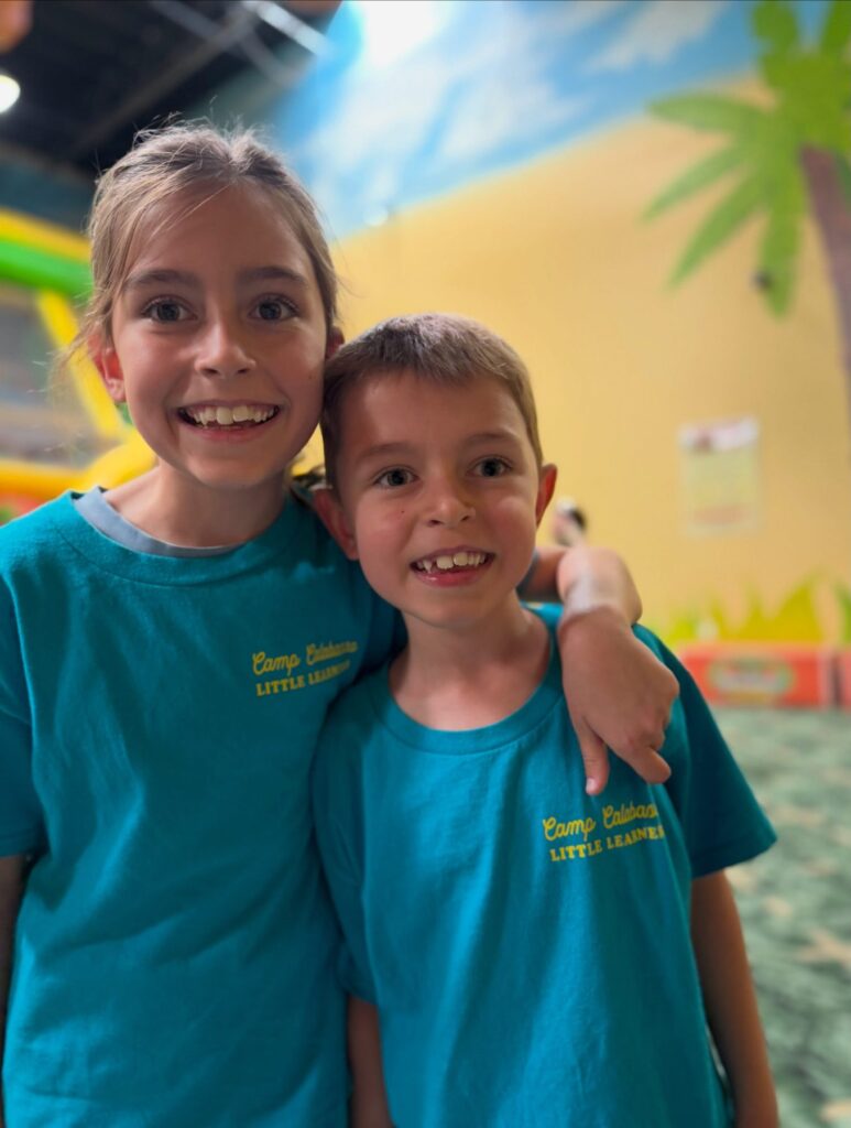Two camp friends posing together at the indoor playground