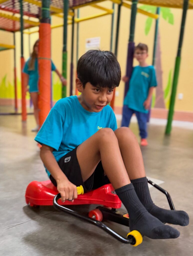 Camper cruising on a ride-on scooter at Scooter's Jungle Valencia